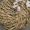 Close-up of a bundle of spherical stones with price tags attached.