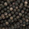 Close-up of a pile of dark gray and black spherical objects
