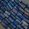 Close-up of blue cylindrical beads arranged in a pattern