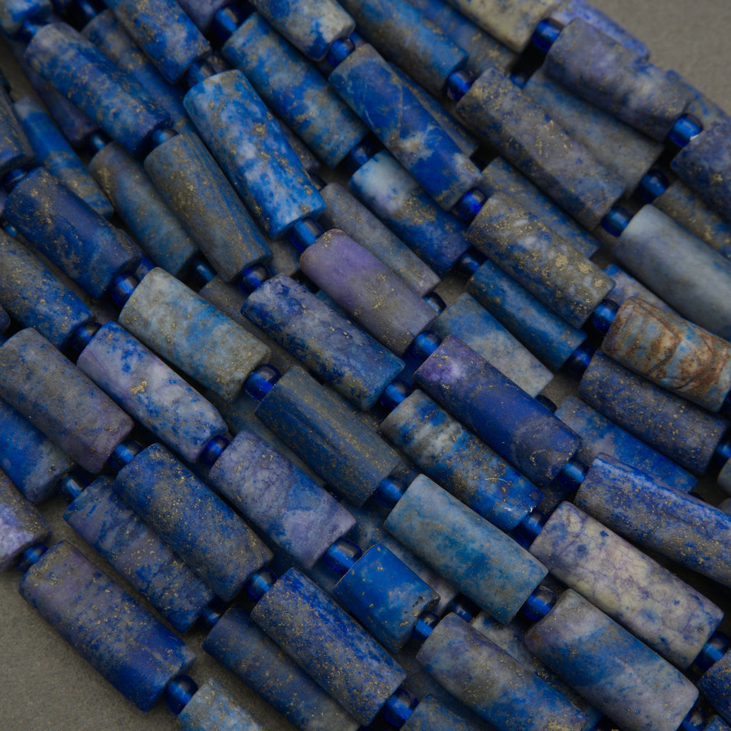 Close-up of blue cylindrical beads arranged in a pattern
