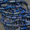 Close-up of blue cylindrical beads on a gray background