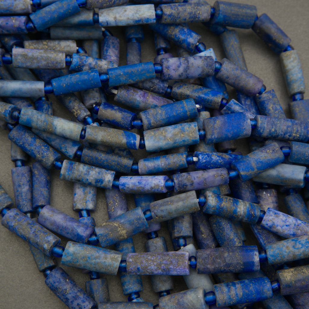 Close-up of blue cylindrical beads on a gray background