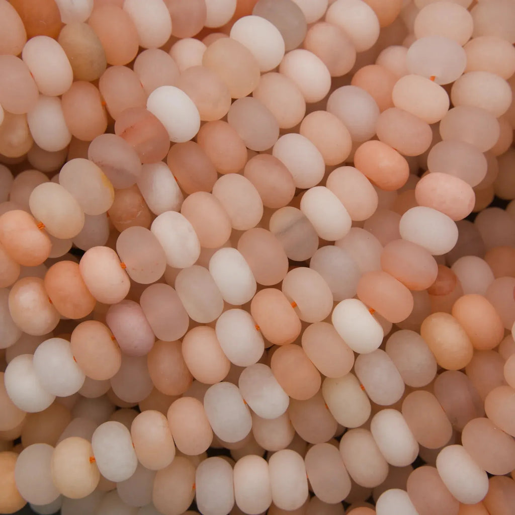 Peach Aventurine matte rondelle gemstone beads on strands.