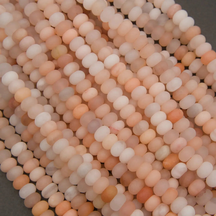 Natural Peach Aventurine rondelle beads with soft peach and cream tones.