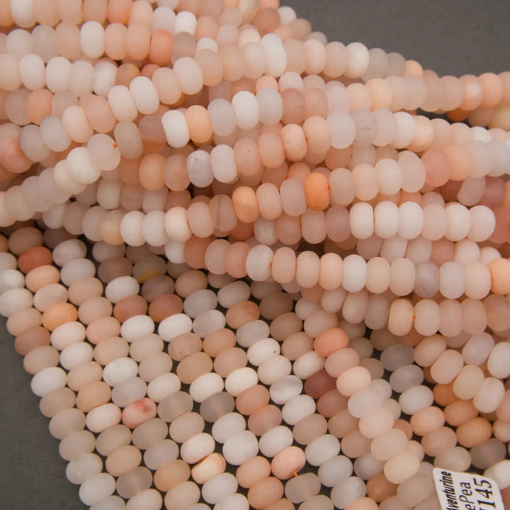 Smooth Peach Aventurine rondelle beads featuring warm pastel colors.