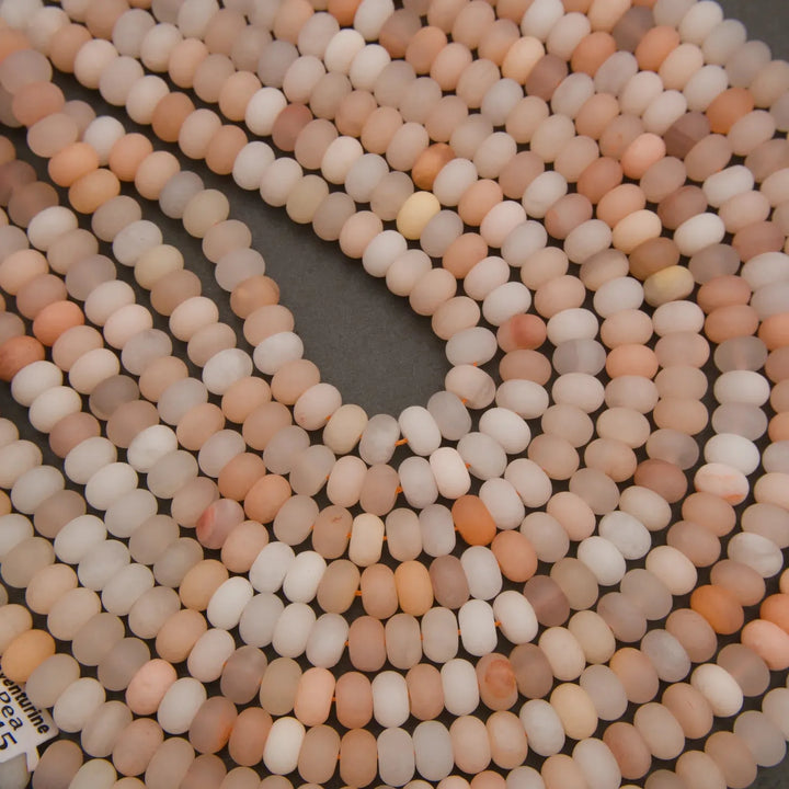 Peach Aventurine gemstone bead strands in assorted peach and ivory shades.