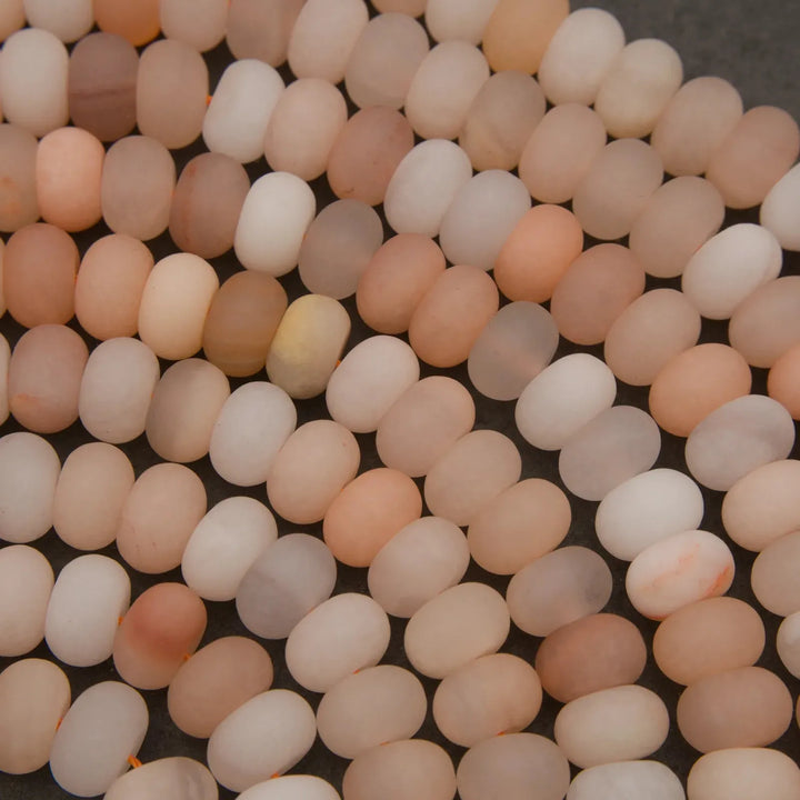 Close-up of matte Peach Aventurine rondelle beads with soft natural coloration.