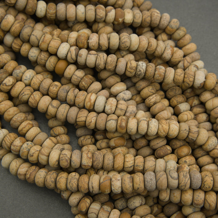 Close-up of a string of beige beads on a gray background