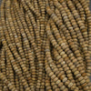 Close-up of a string of brown beads on a gray surface