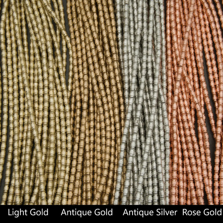 Three strands of beads in light gold, antique gold, and rose gold on a black background.