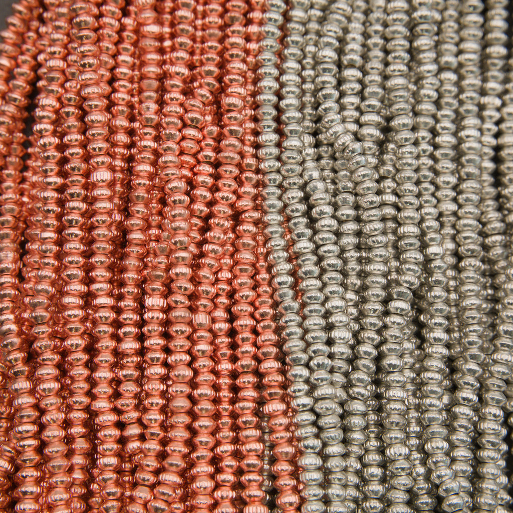 Close-up of red and silver beaded strands