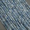 Close-up of natural blue kyanite gemstone beads in light denim tones