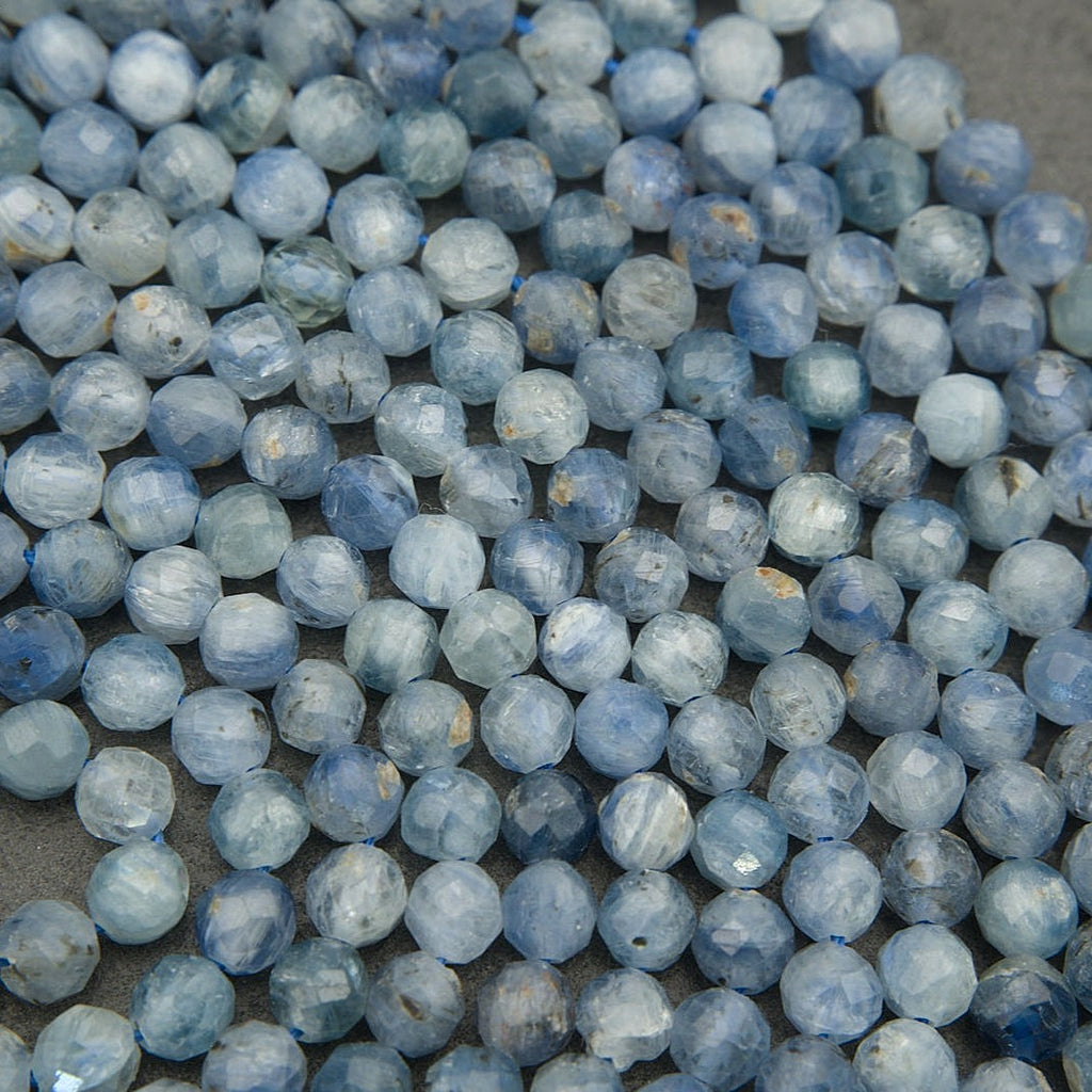 Detailed macro of blue kyanite beads showing natural inclusions and shimmer
