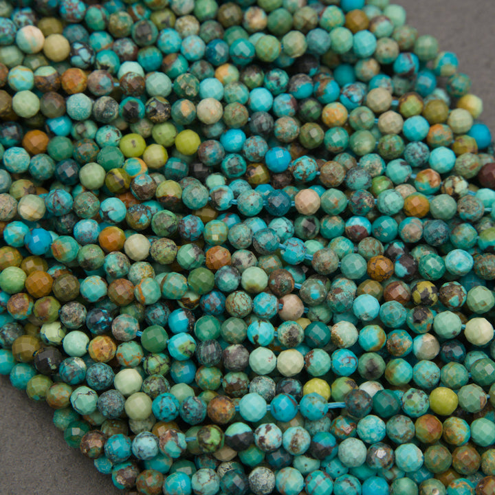 A pile of faceted round turquoise beads in various shades of blue-green, teal, green, brown, and cream, filling the frame.