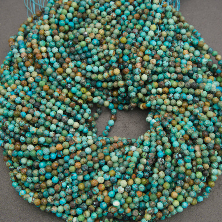 A large coil of round turquoise beads with a distressed, weathered finish in shades of blue, green, and brown, displayed on a neutral gray surface.