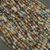 Close-up of multicolored beads arranged in a pattern on a gray background