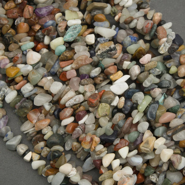 Close-up of multicolored pebbles on a gray surface