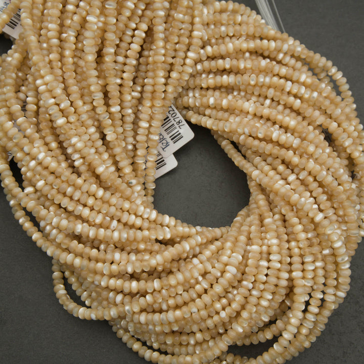 Close-up of beige beads on a dark background