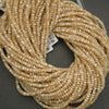 Close-up of beige beads on a dark background