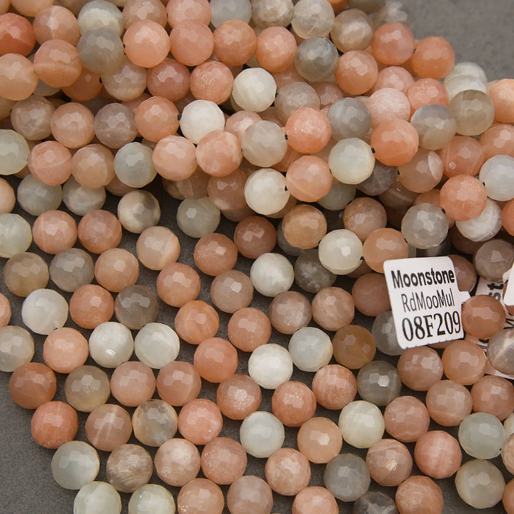 Close-up of multicolored moonstone beads with a label on a gray background