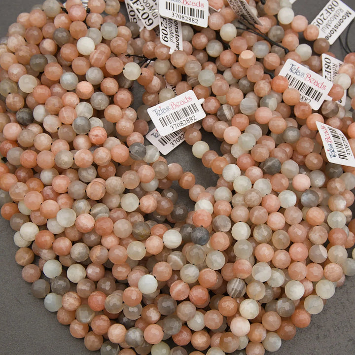 Close-up of multicolored beads with labels on a gray background