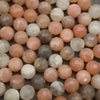 Close-up of multicolored round beads on a textured surface