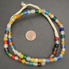 Colorful beaded necklace on a gray background with a coin for scale