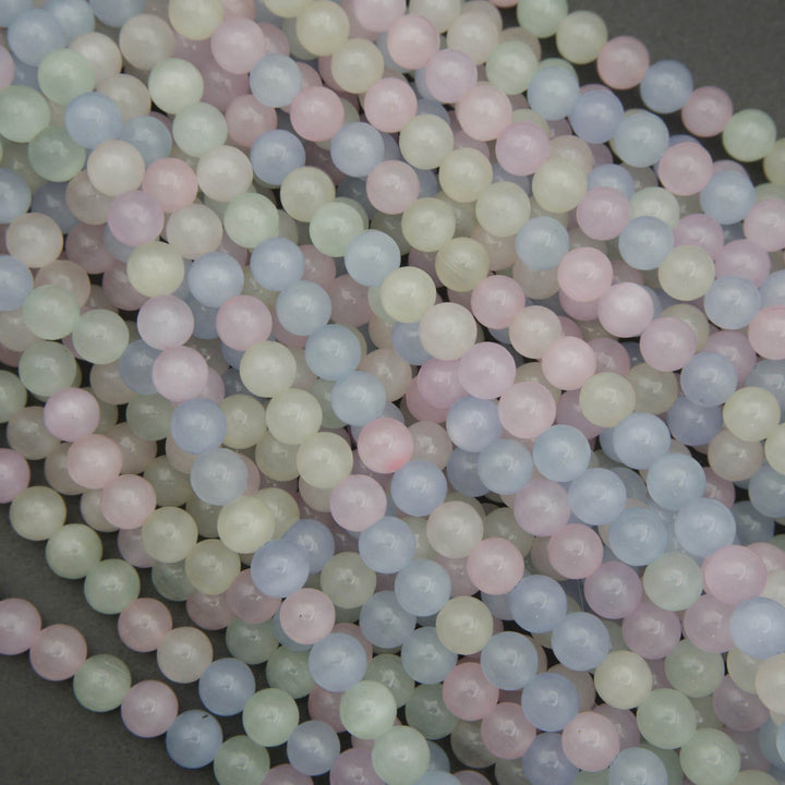 Close-up of pastel-colored round beads on a dark background
