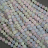 Close-up of pastel-colored round beads on a dark background
