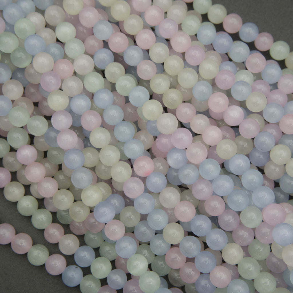 Close-up of pastel-colored round beads on a dark background