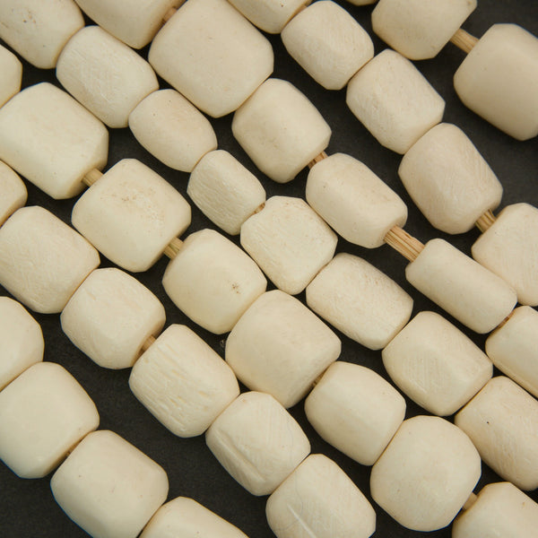 Close-up of beige beads on a dark background