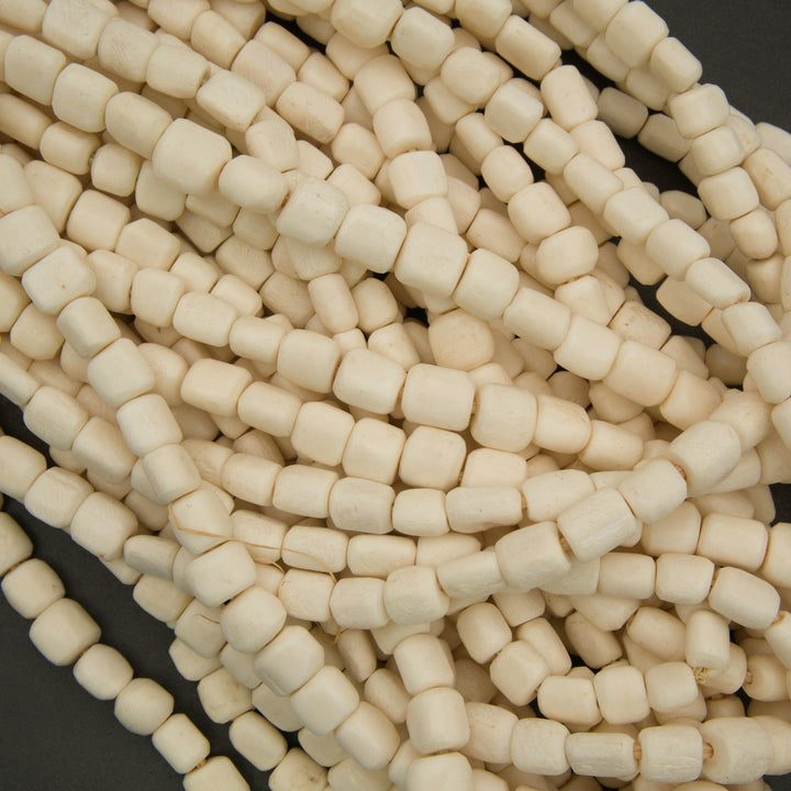Close-up of beige beads on a dark background