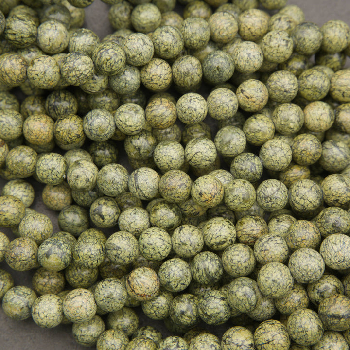 olive green Russian Serpentine beads with intricate black web-like patterns