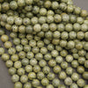 Natural Russian Serpentine round beads featuring earthy green tones and dark veining