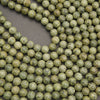Strands of Russian Serpentine beads with natural mottling and fine dark matrix