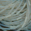 Stack of translucent blue plastic tubes on a dark background