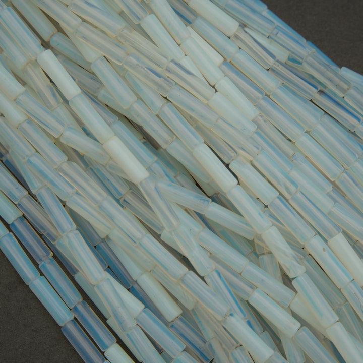 Close-up of translucent blue and clear plastic tubes on a dark surface