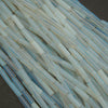 Close-up of translucent blue and clear plastic tubes on a dark surface