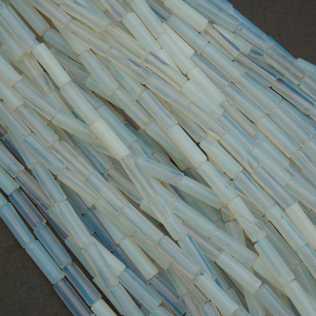 Close-up of translucent blue and clear plastic tubes on a dark surface