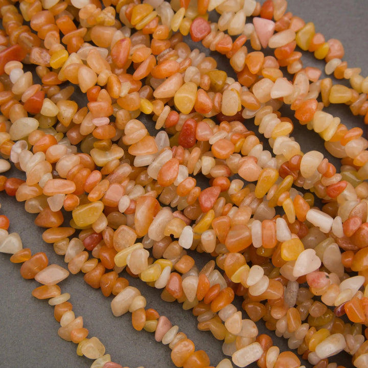 Close-up of a string of multicolored small stones on a gray background
