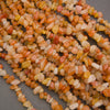 Close-up of a string of multicolored small stones on a gray background