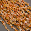 Close-up of a string of multicolored small stones on a gray background