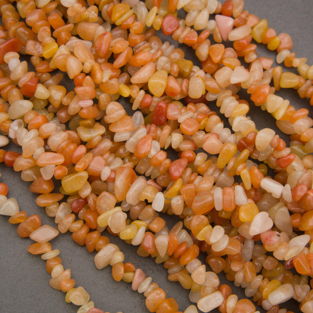 Close-up of a string of multicolored small stones on a gray background