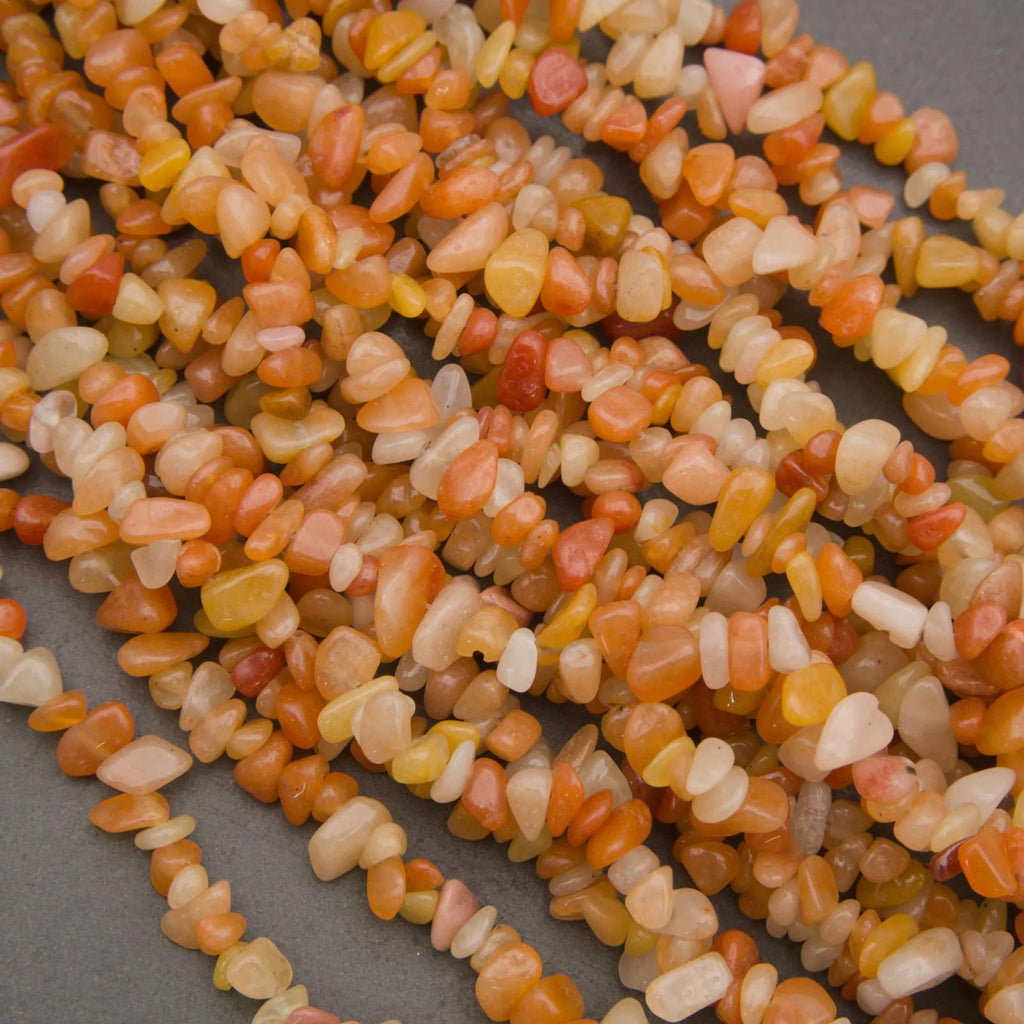 Close-up of a string of multicolored small stones on a gray background