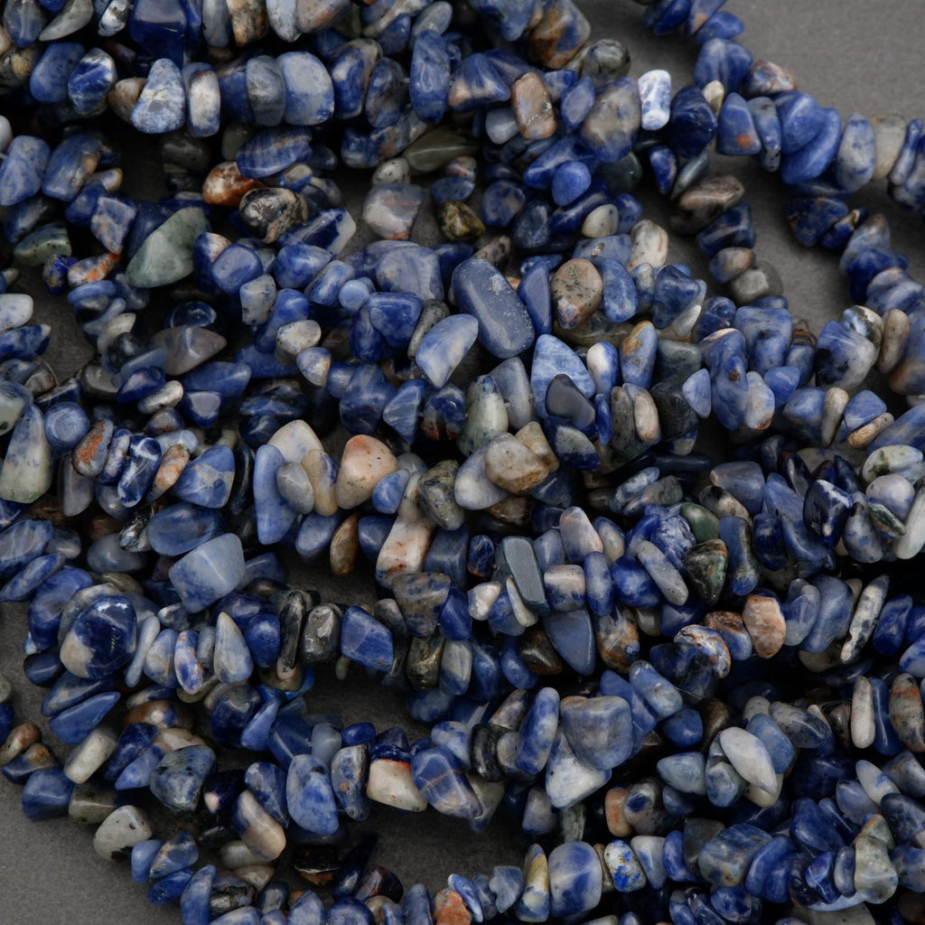 Necklace made of blue and white pebble stones on a dark background