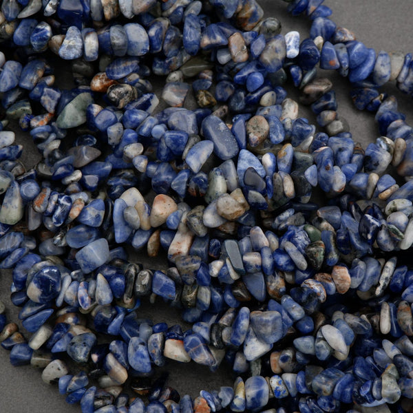 Necklace made of blue and white pebble stones on a dark background
