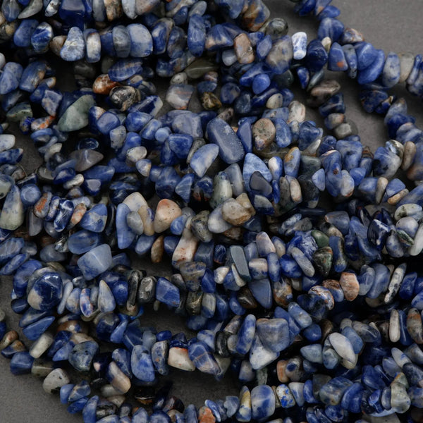 Necklace made of blue and white pebble stones on a dark background