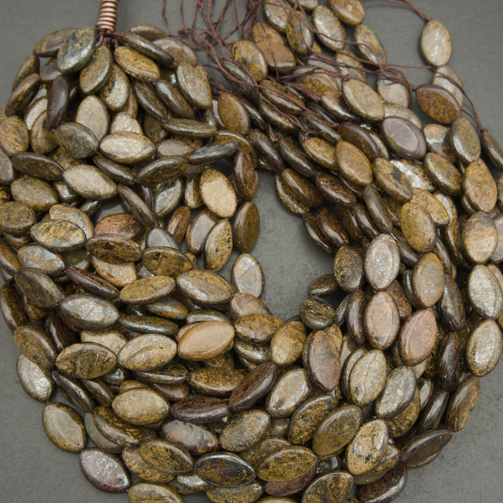 Necklace made of oval-shaped stones on a gray background