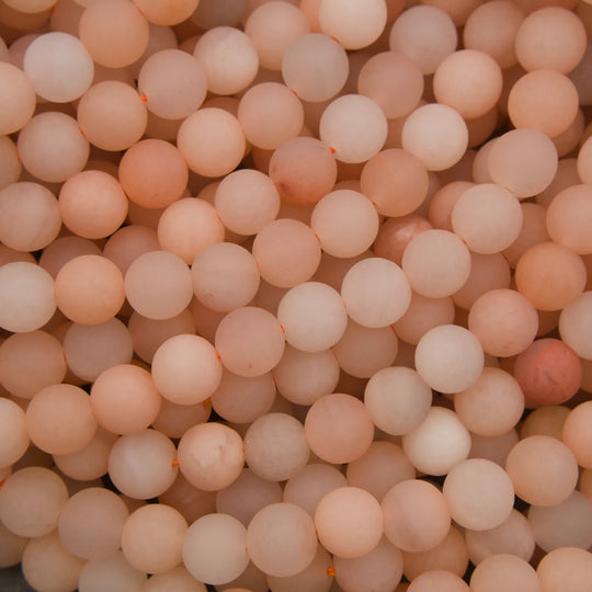 Close-up of a large number of light pink beads.