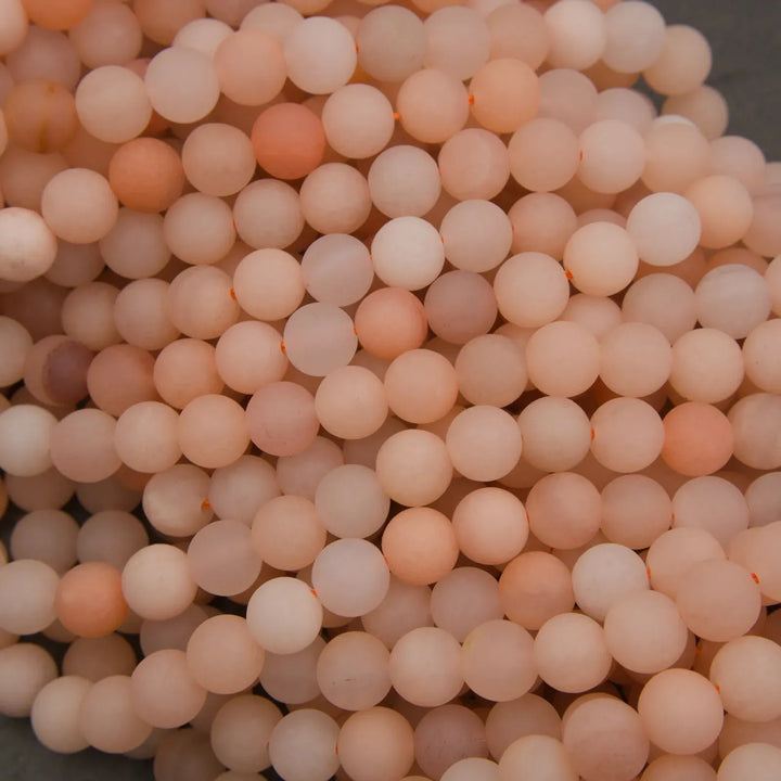 Close-up of a pile of light pinkish-beige beads.